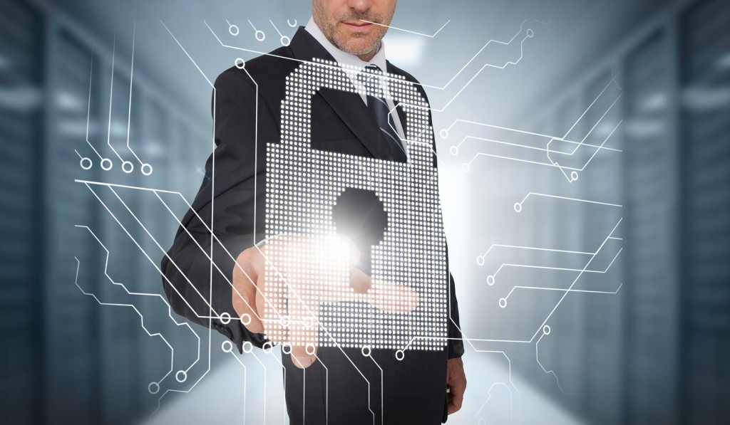 Businessman selecting a futuristic padlock with a data center on